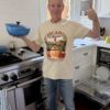 Man wearing DiCapo Wines t shirt in kitchen