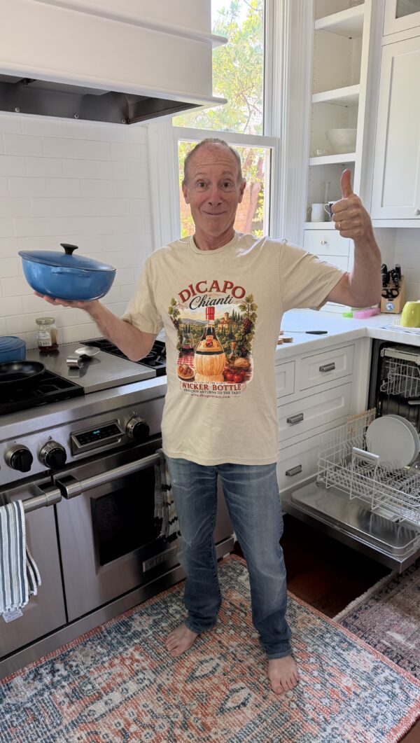 Man wearing DiCapo Wines t shirt in kitchen
